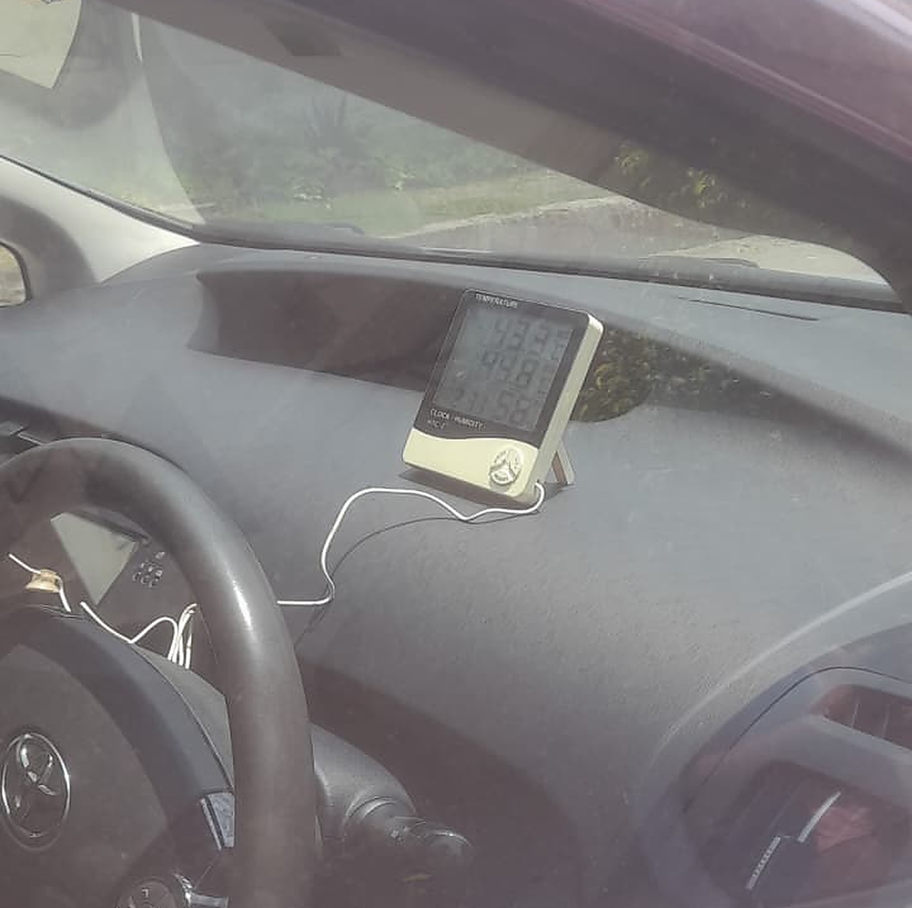 Before UV tint — Toyota Prius dashboard, untinted glass, meter showing 44°C cabin